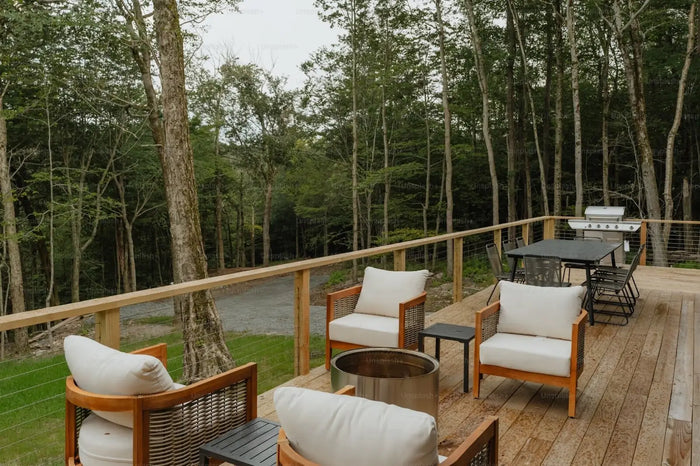 Wooden-framed wicker armchairs with cream cushions optimized for deck design enhancing an outdoor space seating area