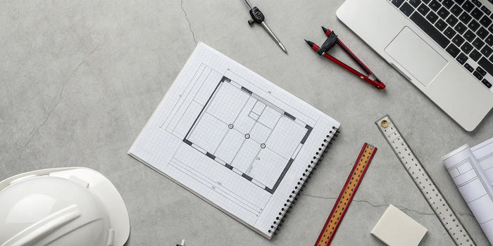 A site plan for a garage permit on a desk with a laptop, ready to get submitted.