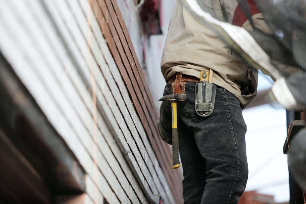 an Wearing Black Denim Pants With Carrying Hammer on Holster