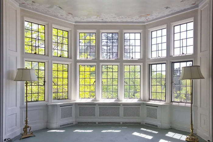 The room with a bay window and black metal frames illustrates how site plan drawings impact architectural design.