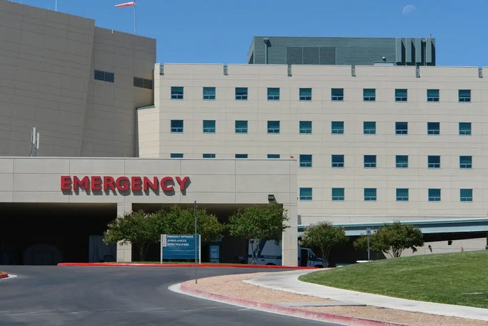 The beige hospital building with a red emergency sign illustrates site plans for the best site plan proposals.