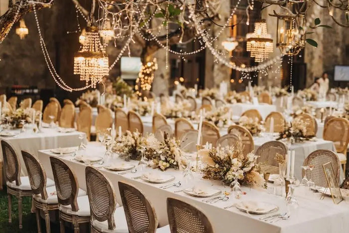 Elegant white tablecloths on banquet tables with dried floral centerpieces enhance site plan event planning ambiance
