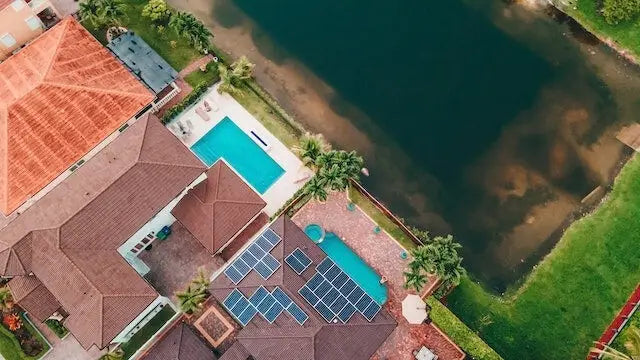 Blue solar panels arranged in rows on a brown roof illustrating solar panel cost and tax credit in ca 2025 guide