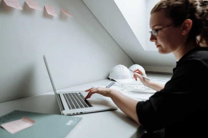 Silver laptop with sleek minimalist design and black keyboard displaying site plan software for 3d site plans article