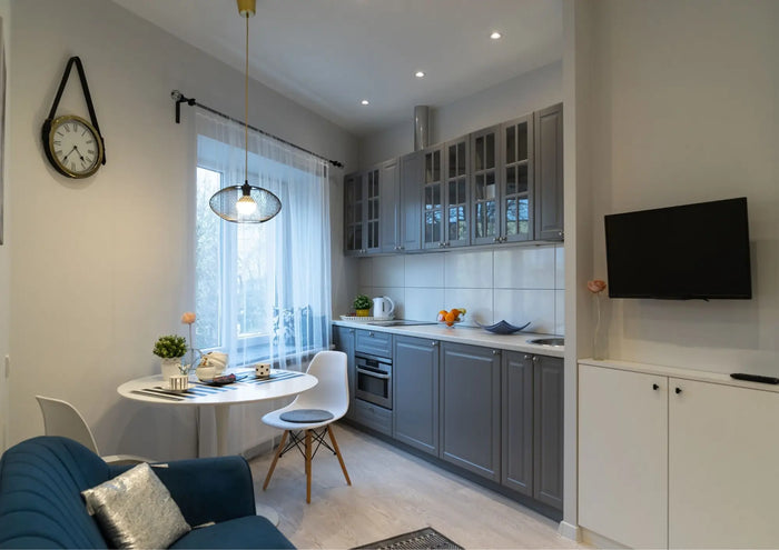 Gray kitchen cabinets with glass-paneled upper doors and modern design ideal for granny flats and granny units interiors