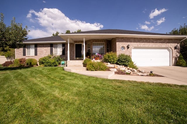 Home with a landscaped yard and surroundings
