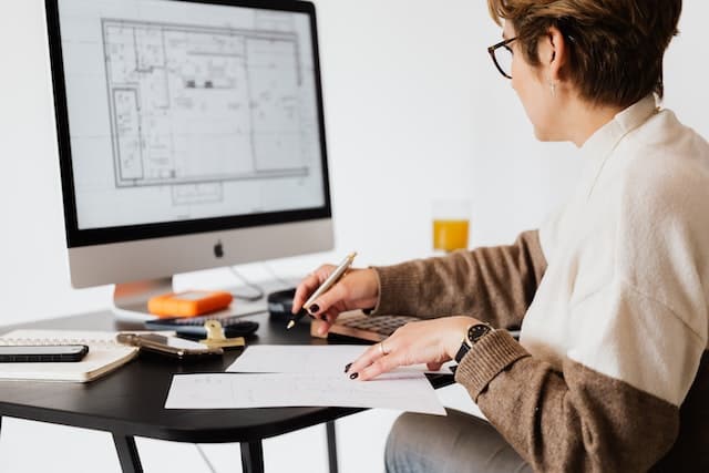 Woman working on a plan on her computer