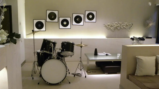 a remodeled basement with white walls, white floors, and music equipment