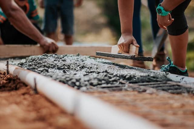 construction team laying home foundation