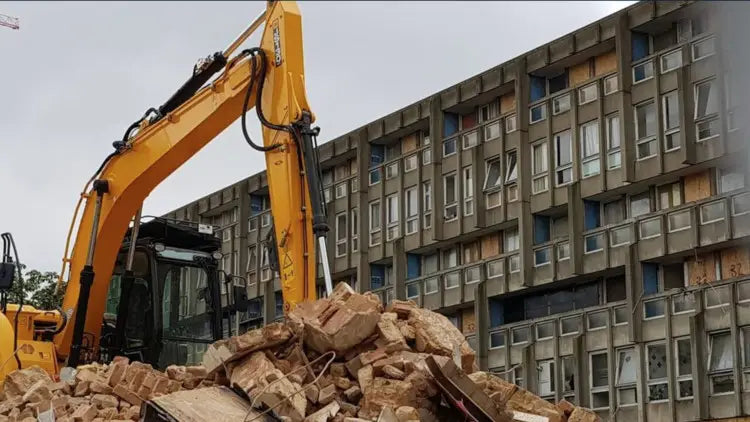 A partially collapsed white building with exposed brick and rubble illustrating demolition work requiring a demolition permit.