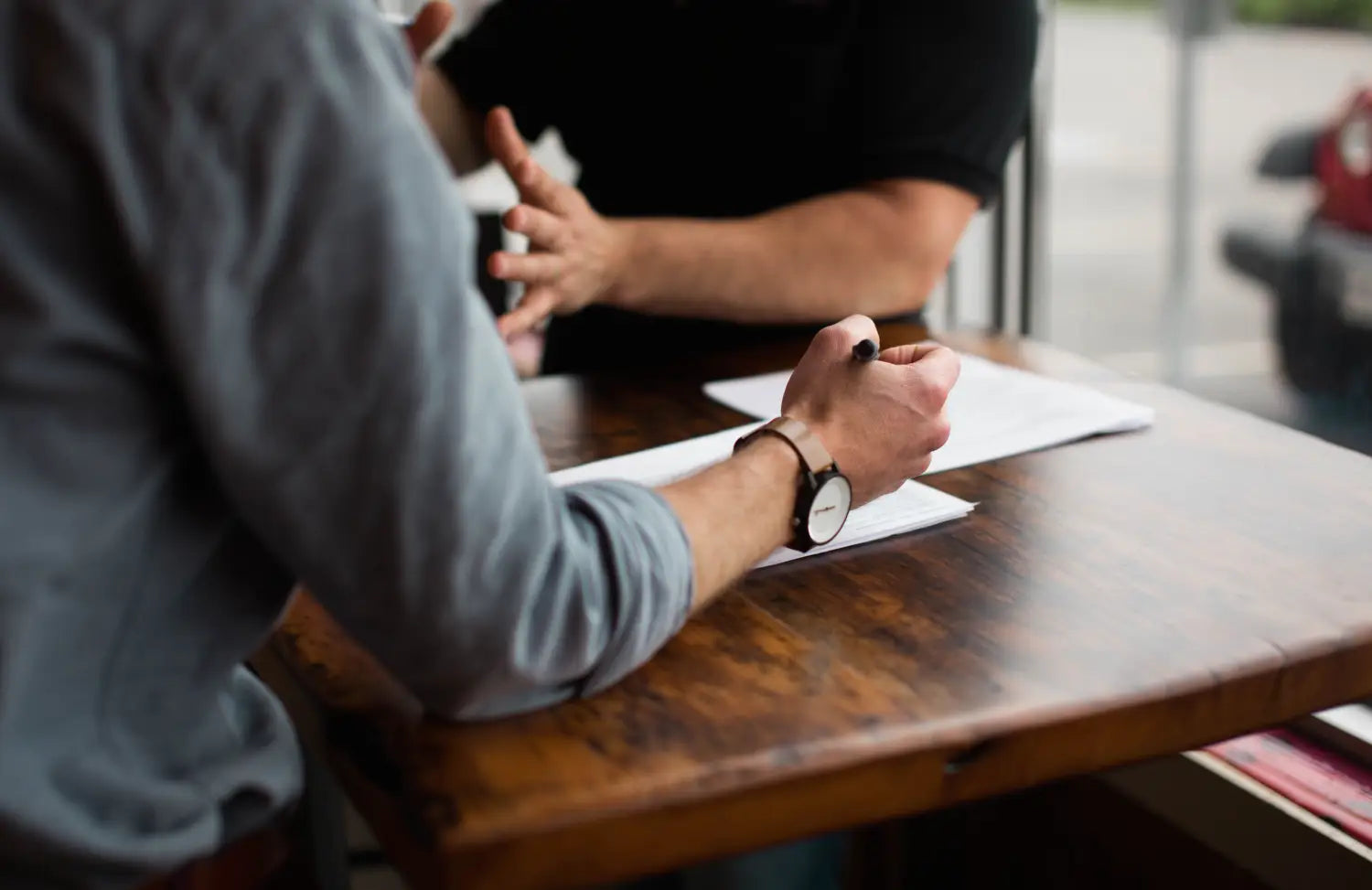 Image of people working on desk.