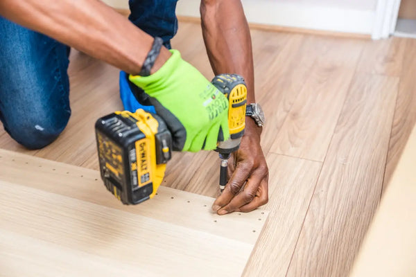 construction worker nailing wood down