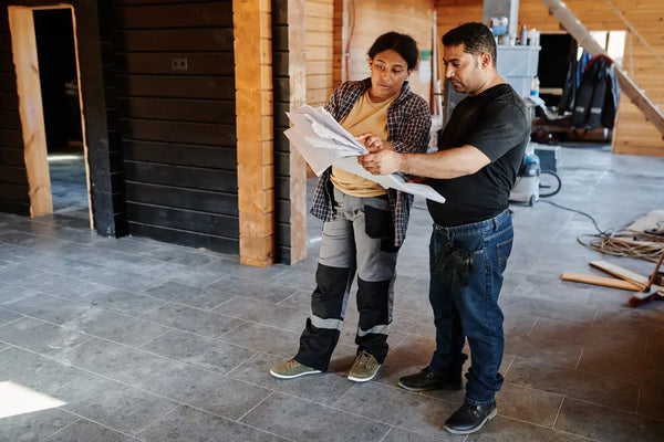 a couple checking on floor plans