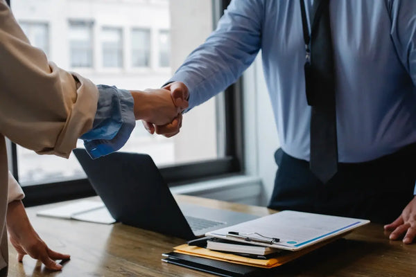 contractor and home owner shaking hands