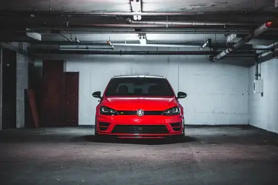Empty garage with only a red car