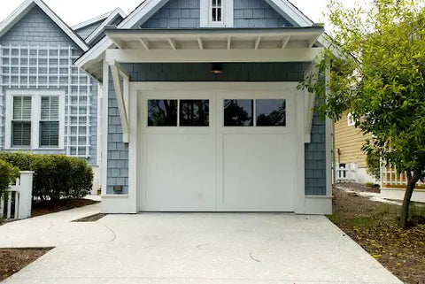 blue paneled house with white garage