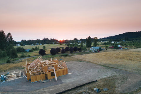 valley sunrise with unfinished house