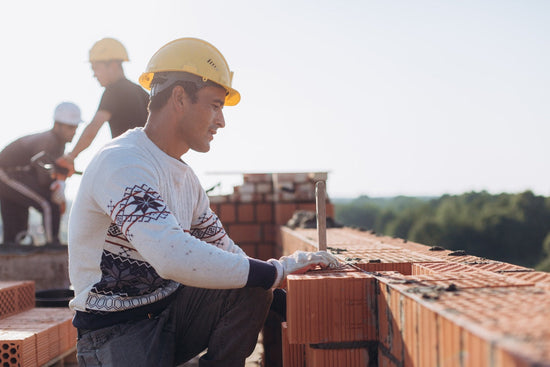 man working on the foundation of a house 