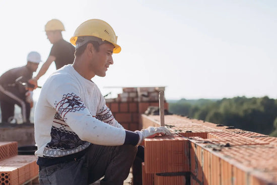 man working on the foundation of a house